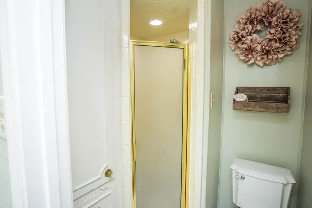 a view of a room with wooden floor table and windows