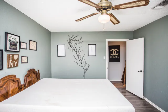 a view of a hallway with wooden floor and staircase