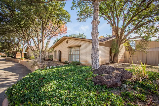 a view of a white house with a yard