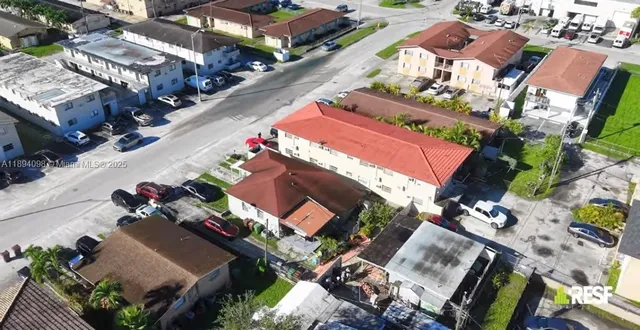 an aerial view of a house with a yard swimming pool and outdoor seating