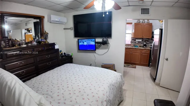 a bedroom with a bed and a mirror on dresser