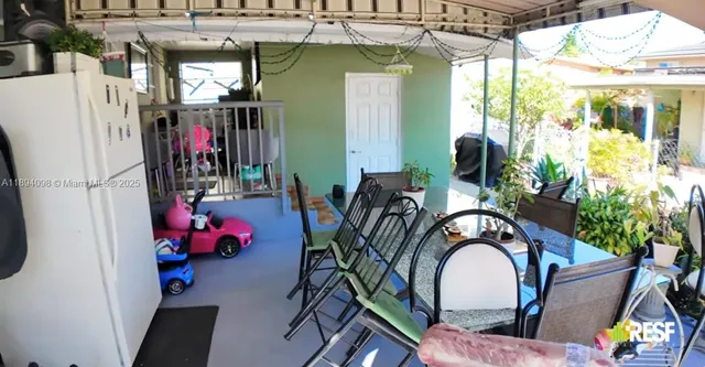 a view of a chairs and table in a patio