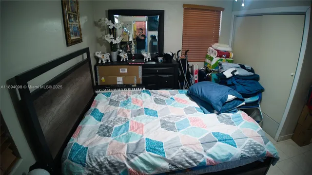 a kitchen with stainless steel appliances kitchen island granite countertop a refrigerator a stove a sink a dining table and chairs with wooden floor