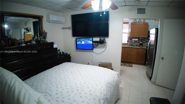 a view of a patio with table and chairs and potted plants
