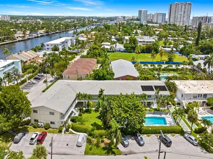 an aerial view of residential houses with outdoor space and ocean view