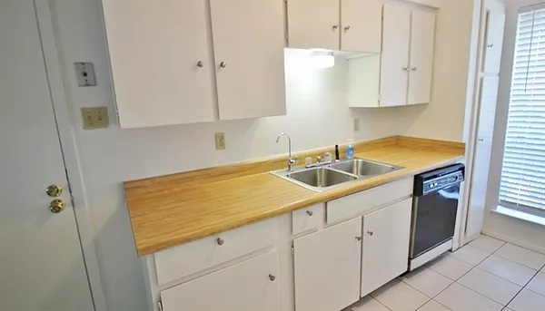 a kitchen that has a sink and a stove