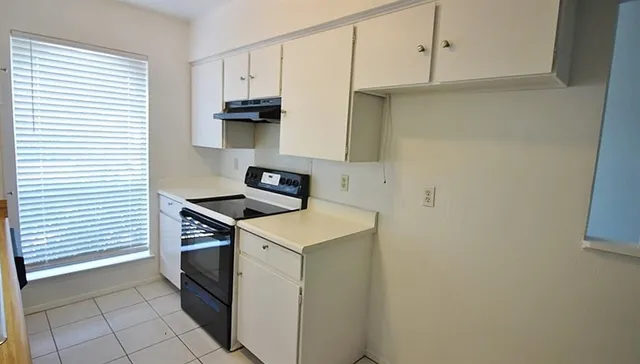 a kitchen with stainless steel appliances a stove and a refrigerator
