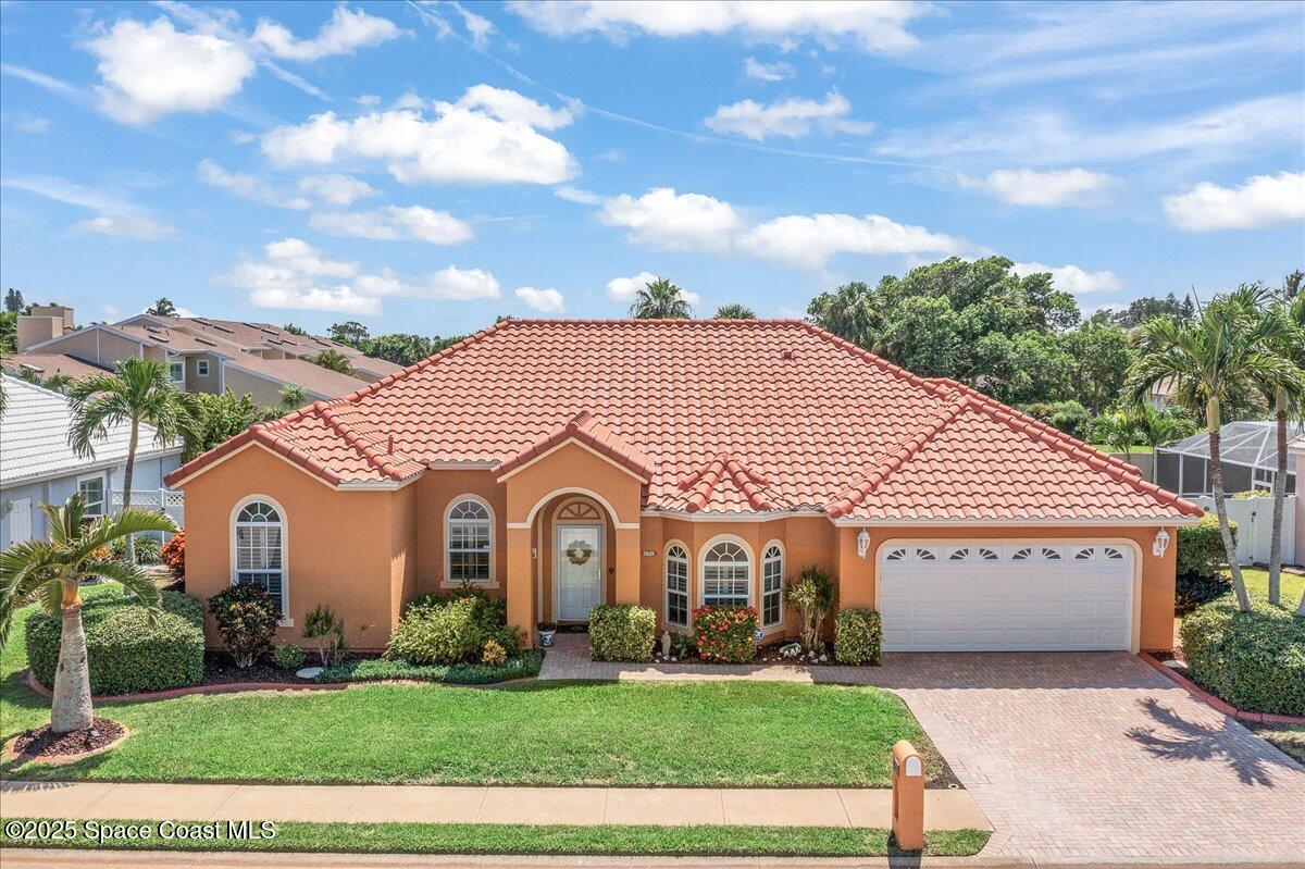 a view of a white house with a yard