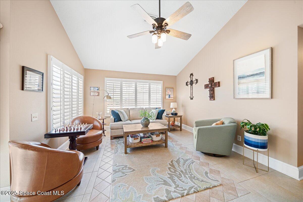 171 Seaview Street Melbourne Beach, FL 32951 - Photo 13 of 44 a living room with furniture and a large window
