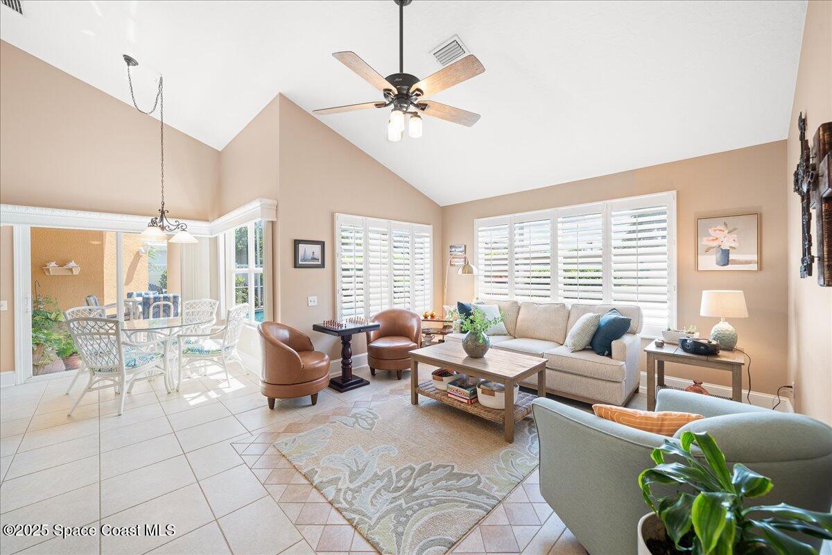 171 Seaview Street Melbourne Beach, FL 32951 - Photo 14 of 44 a living room with furniture and large windows