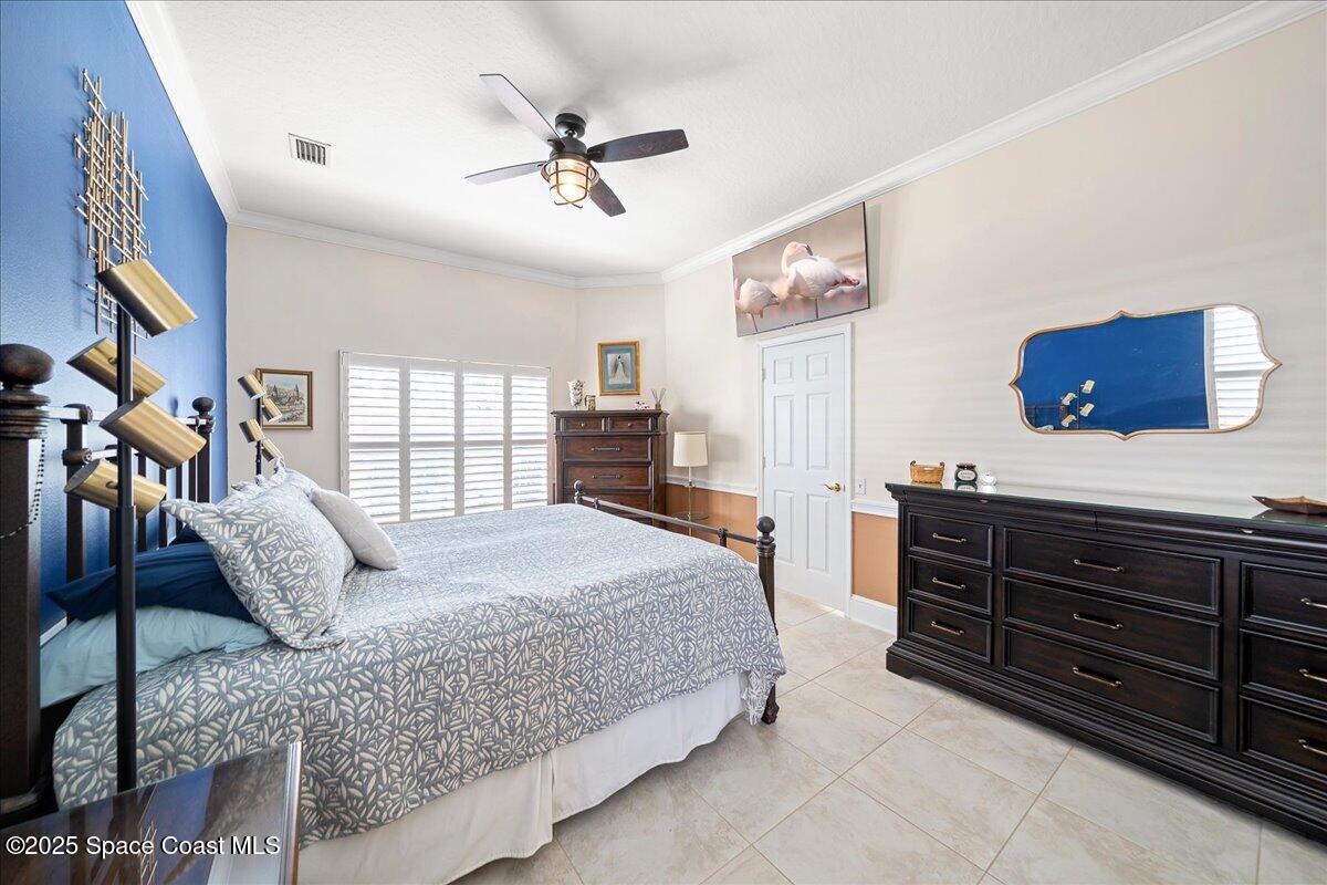 171 Seaview Street Melbourne Beach, FL 32951 - Photo 16 of 44 a bedroom with a large bed and a dresser