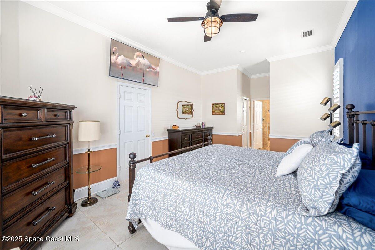 171 Seaview Street Melbourne Beach, FL 32951 - Photo 17 of 44 a bedroom with a bed and wooden floor