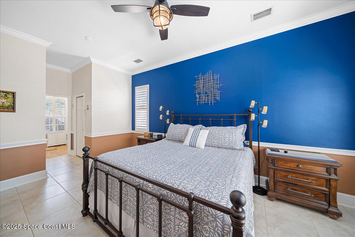 171 Seaview Street Melbourne Beach, FL 32951 - Photo 18 of 44 a bedroom with a bed and a chandelier