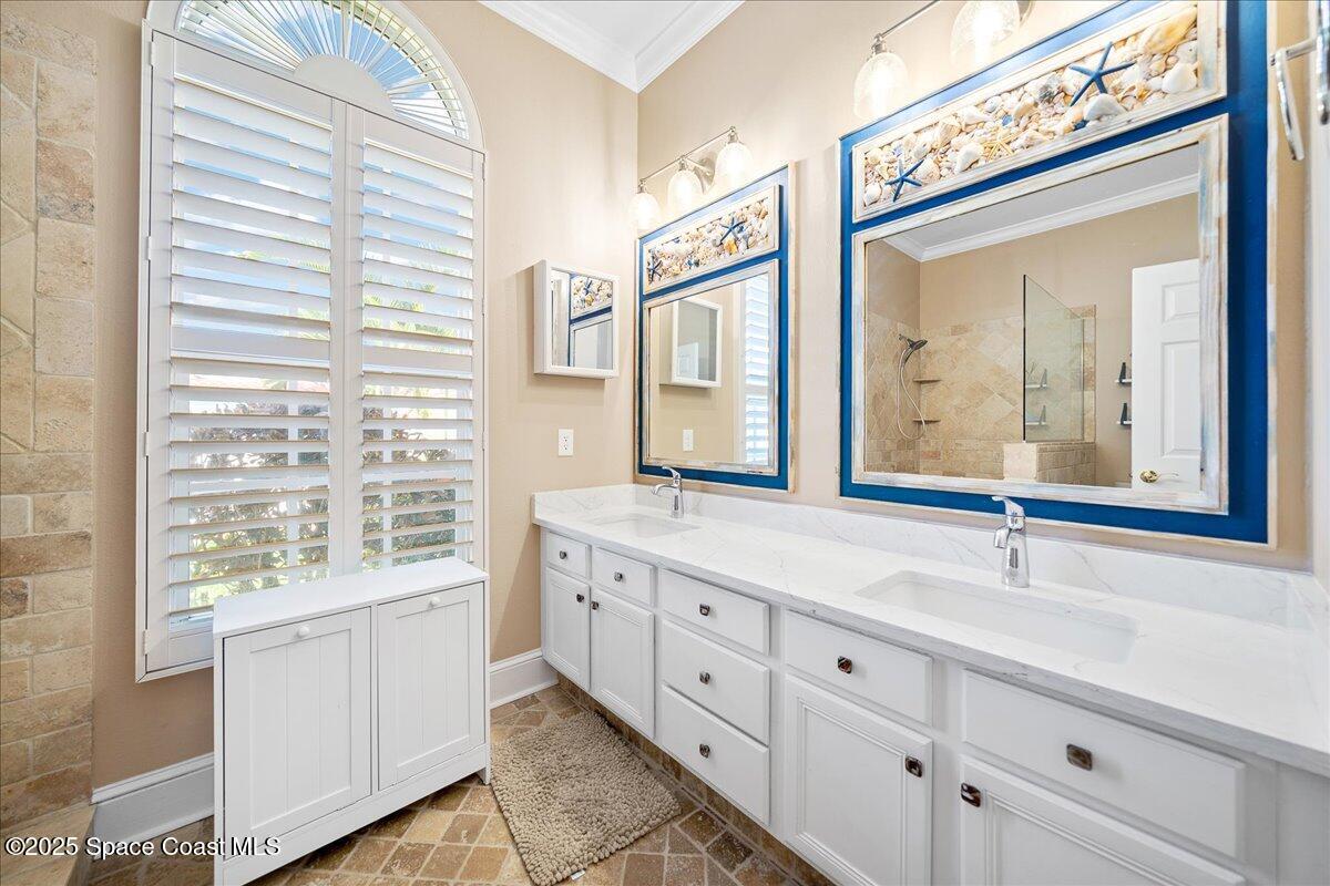 171 Seaview Street Melbourne Beach, FL 32951 - Photo 20 of 44 a bathroom with a sink mirror and a window