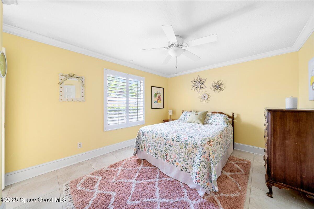 171 Seaview Street Melbourne Beach, FL 32951 - Photo 23 of 44 a bedroom with a bed and a window