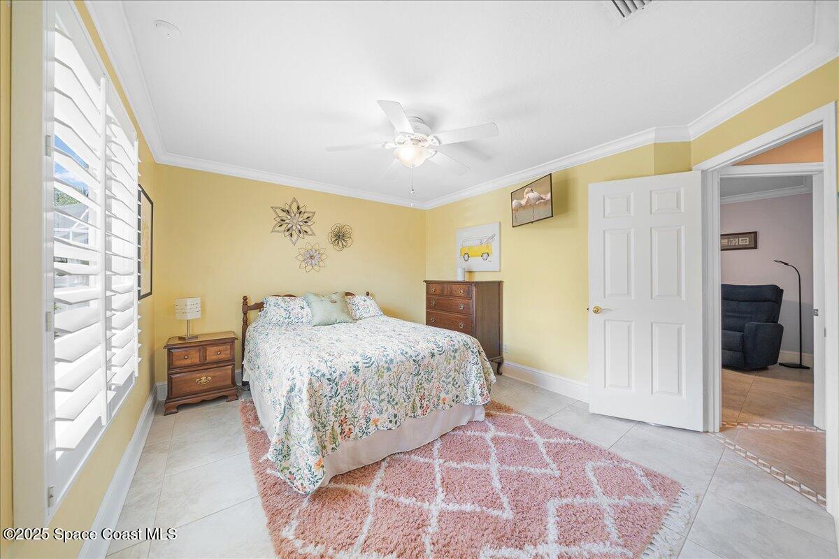 171 Seaview Street Melbourne Beach, FL 32951 - Photo 24 of 44 a spacious bedroom with a bed and a chandelier