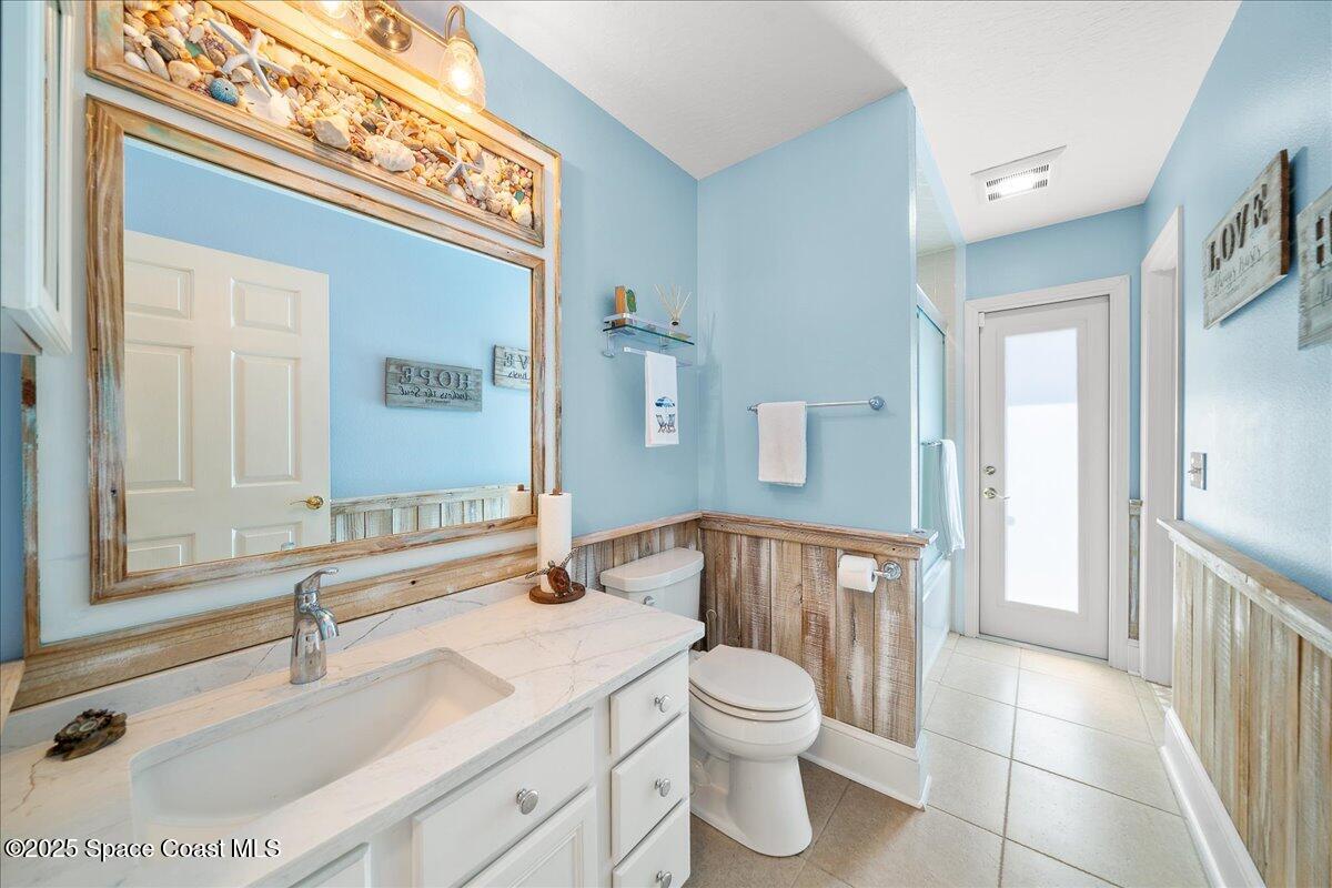 171 Seaview Street Melbourne Beach, FL 32951 - Photo 26 of 44 a bathroom with a sink a toilet and a large mirror