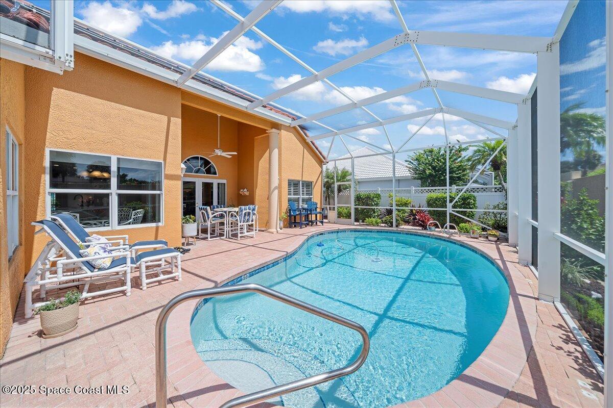 171 Seaview Street Melbourne Beach, FL 32951 - Photo 30 of 44 a view of a swimming pool with a patio