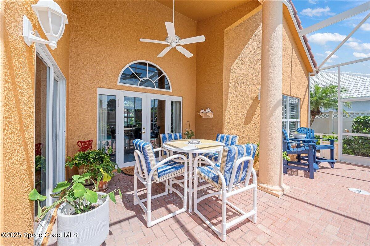 171 Seaview Street Melbourne Beach, FL 32951 - Photo 31 of 44 a view of a patio with table and chairs and potted plants