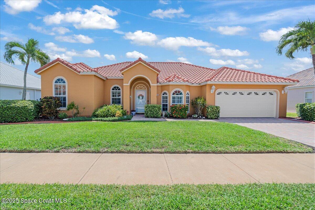 171 Seaview Street Melbourne Beach, FL 32951 - Photo 38 of 44 a front view of a house with a garden and plants