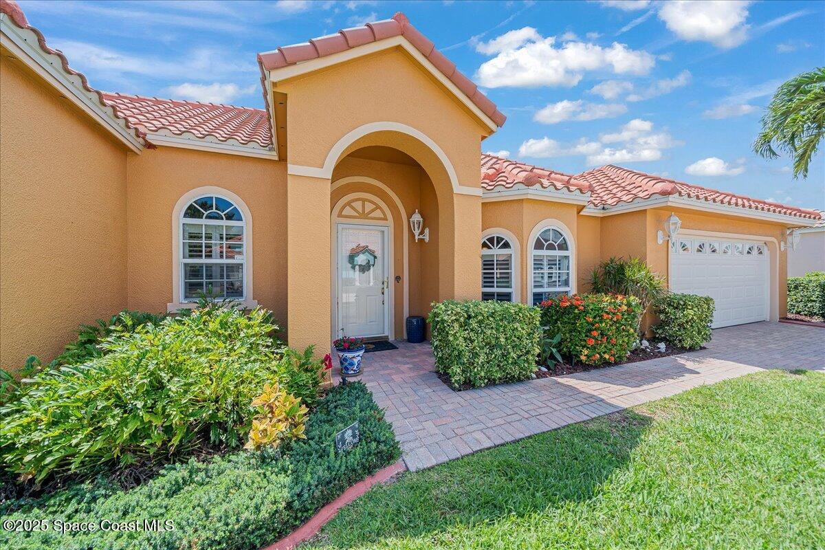 171 Seaview Street Melbourne Beach, FL 32951 - Photo 4 of 44 a front view of a house with garden