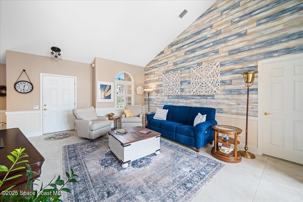 171 Seaview Street Melbourne Beach, FL 32951 - Photo 5 of 44 a living room with furniture and a fireplace