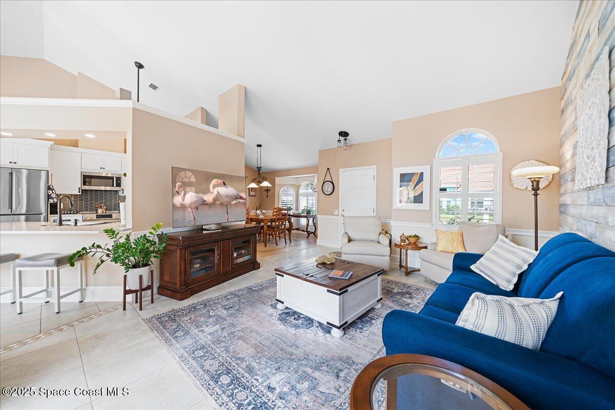171 Seaview Street Melbourne Beach, FL 32951 - Photo 7 of 44 a living room with furniture and a large window