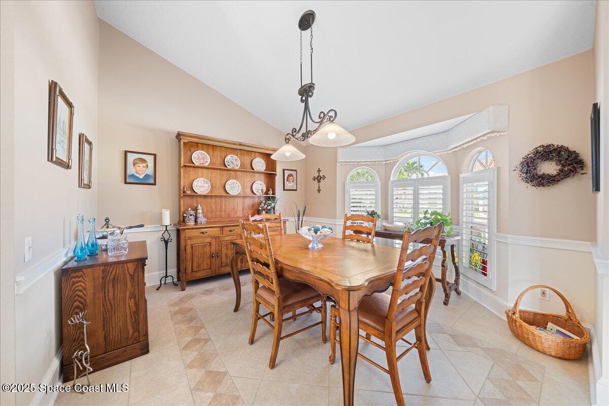 171 Seaview Street Melbourne Beach, FL 32951 - Photo 8 of 44 a view of a dining room with furniture and a chandelier