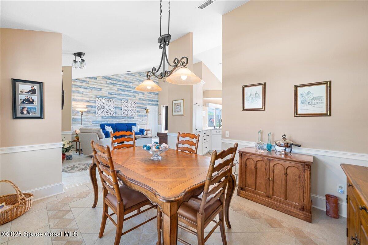 171 Seaview Street Melbourne Beach, FL 32951 - Photo 9 of 44 a dining room with a wooden table and chairs