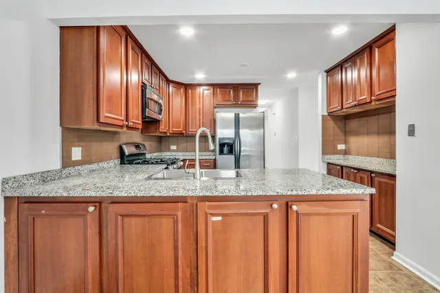 a kitchen with stainless steel appliances granite countertop cabinets and a granite counter tops