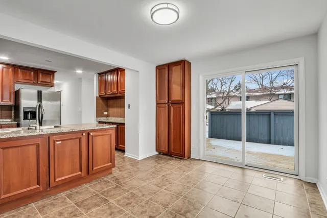 a view of a kitchen with a sink and a refrigerator