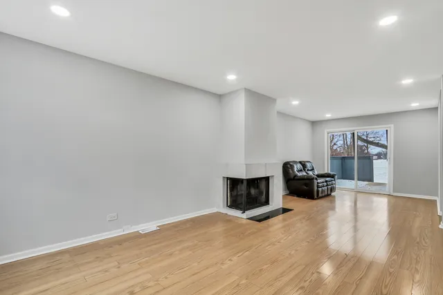 a view of livingroom with hardwood floor and a rug