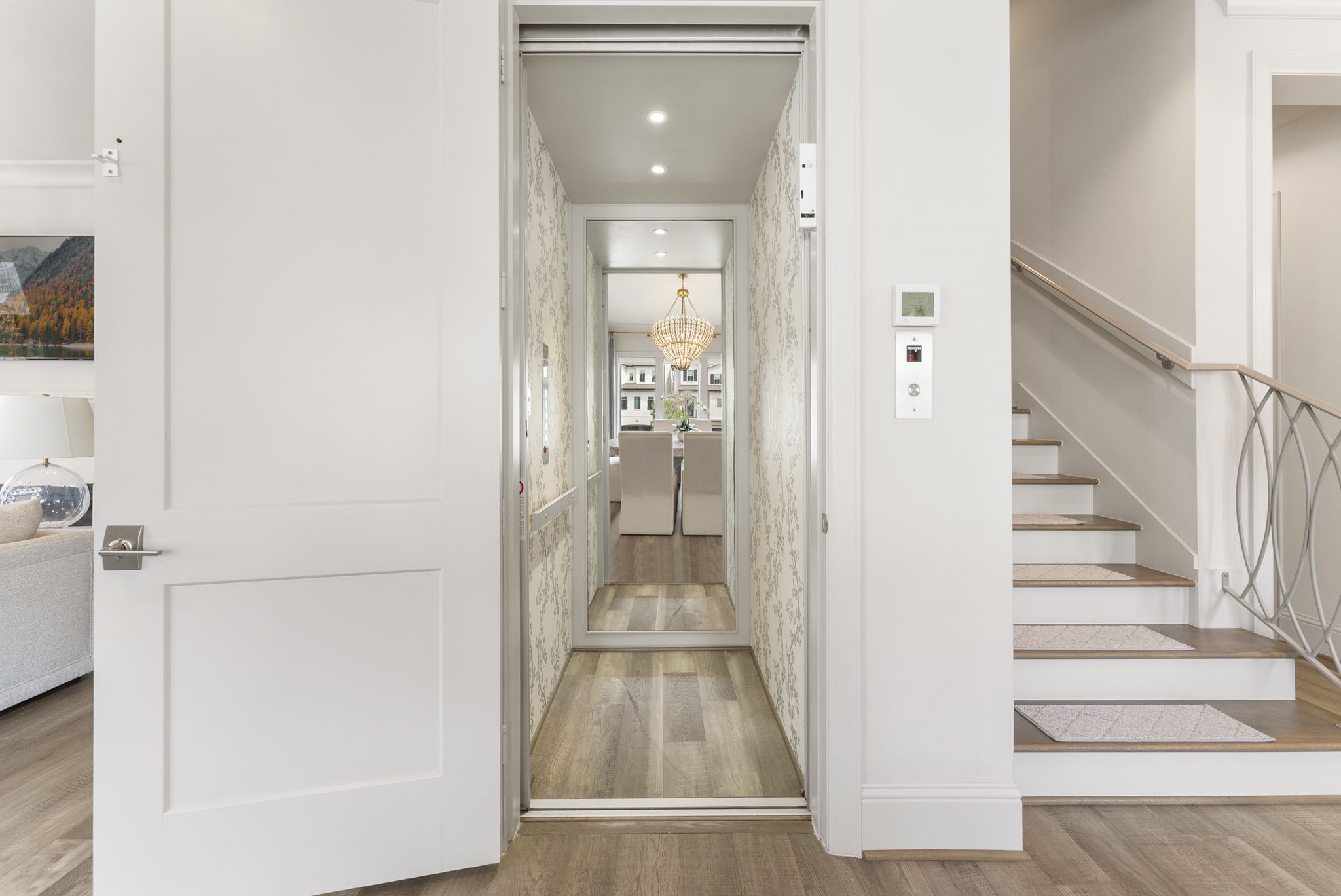 10 Nautical Terrace Way The Woodlands, TX 77380 - Photo 10 of 28 Private residential elevator serving all four floors, finished in designer wallpaper, a coveted convenience in luxury townhome living.