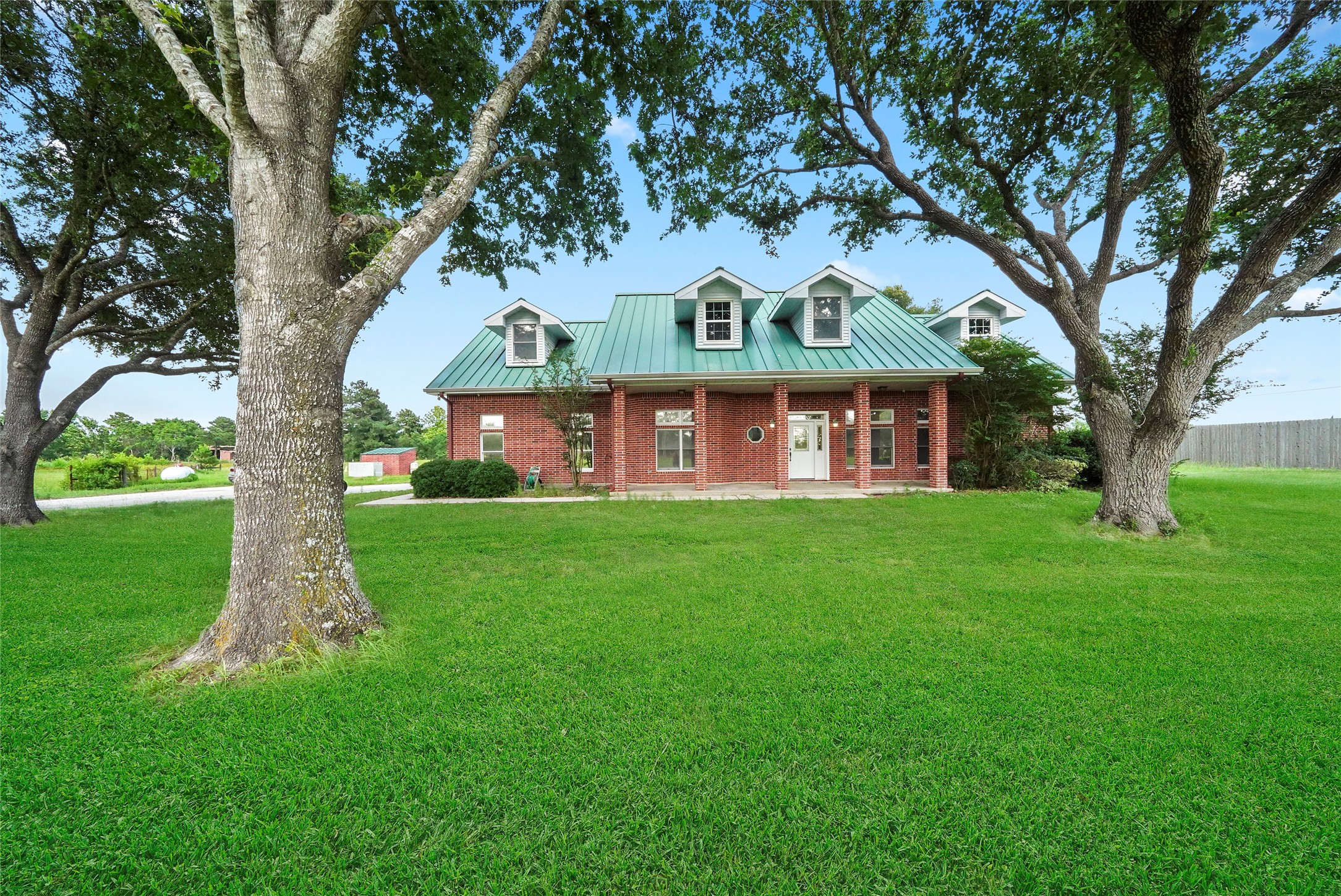 19250 Becker Road Hockley, TX 77447 - Photo 13 of 38 Welcome to your private country escape. This steel-framed, full-brick home sits on a 1.5-acre lot with a metal roof and classic dormer windows.