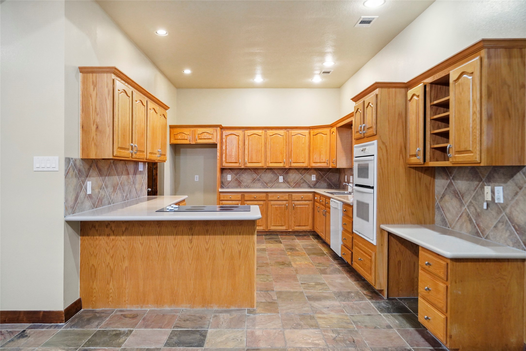 19250 Becker Road Hockley, TX 77447 - Photo 21 of 38 a large kitchen with stainless steel appliances granite countertop a stove a sink dishwasher and a refrigerator