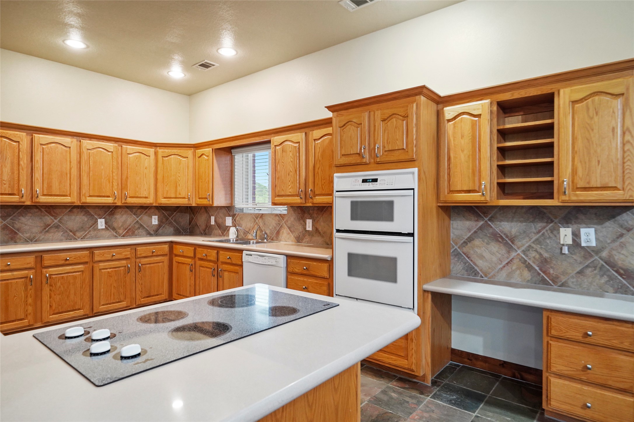19250 Becker Road Hockley, TX 77447 - Photo 22 of 38 a kitchen with stainless steel appliances a stove microwave and cabinets