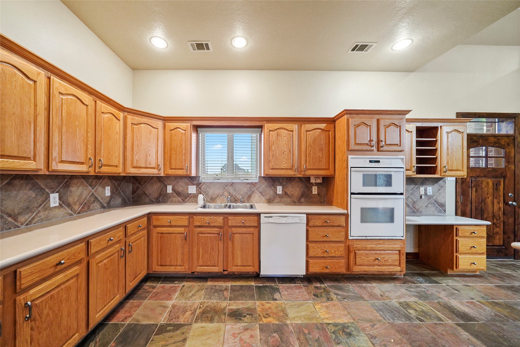 19250 Becker Road Hockley, TX 77447 - Photo 23 of 38 a large kitchen with stainless steel appliances granite countertop a stove sink and cabinets