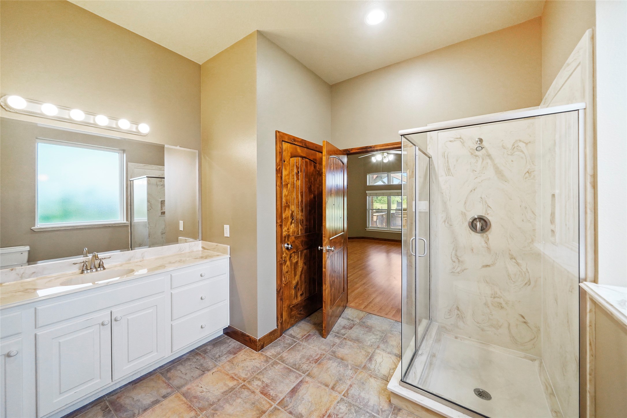 19250 Becker Road Hockley, TX 77447 - Photo 26 of 38 a spacious bathroom with a shower sink and mirror