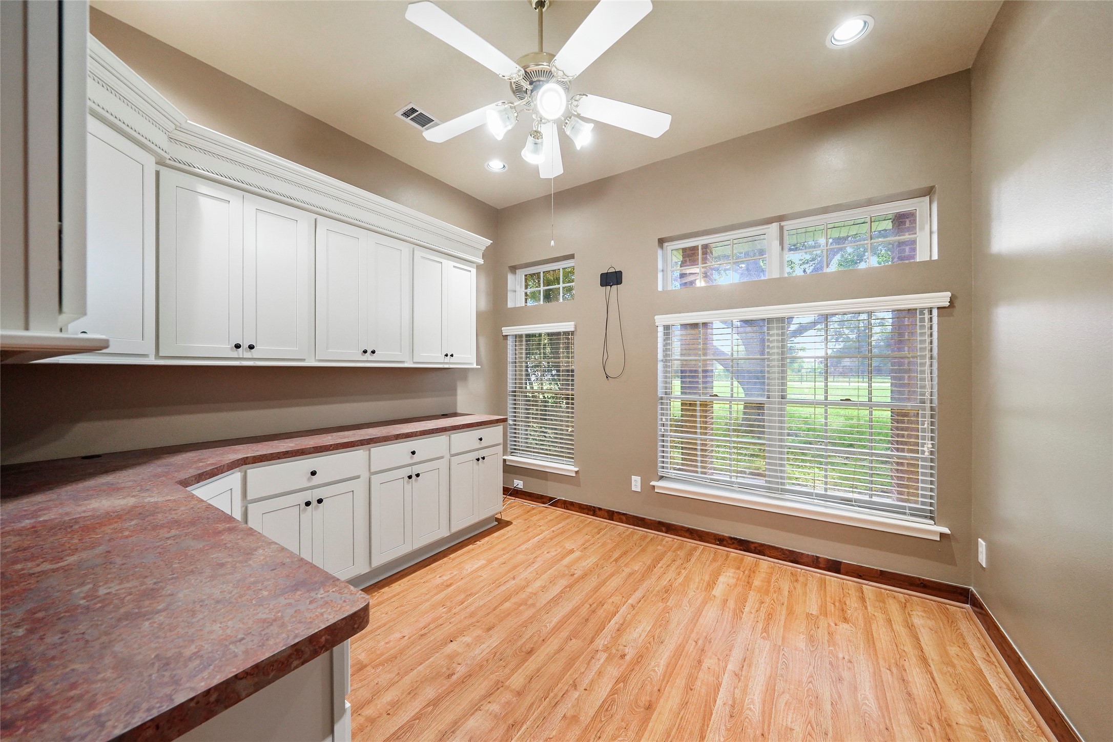 19250 Becker Road Hockley, TX 77447 - Photo 27 of 38 a kitchen with stainless steel appliances granite countertop a stove a sink and white cabinets with wooden floor