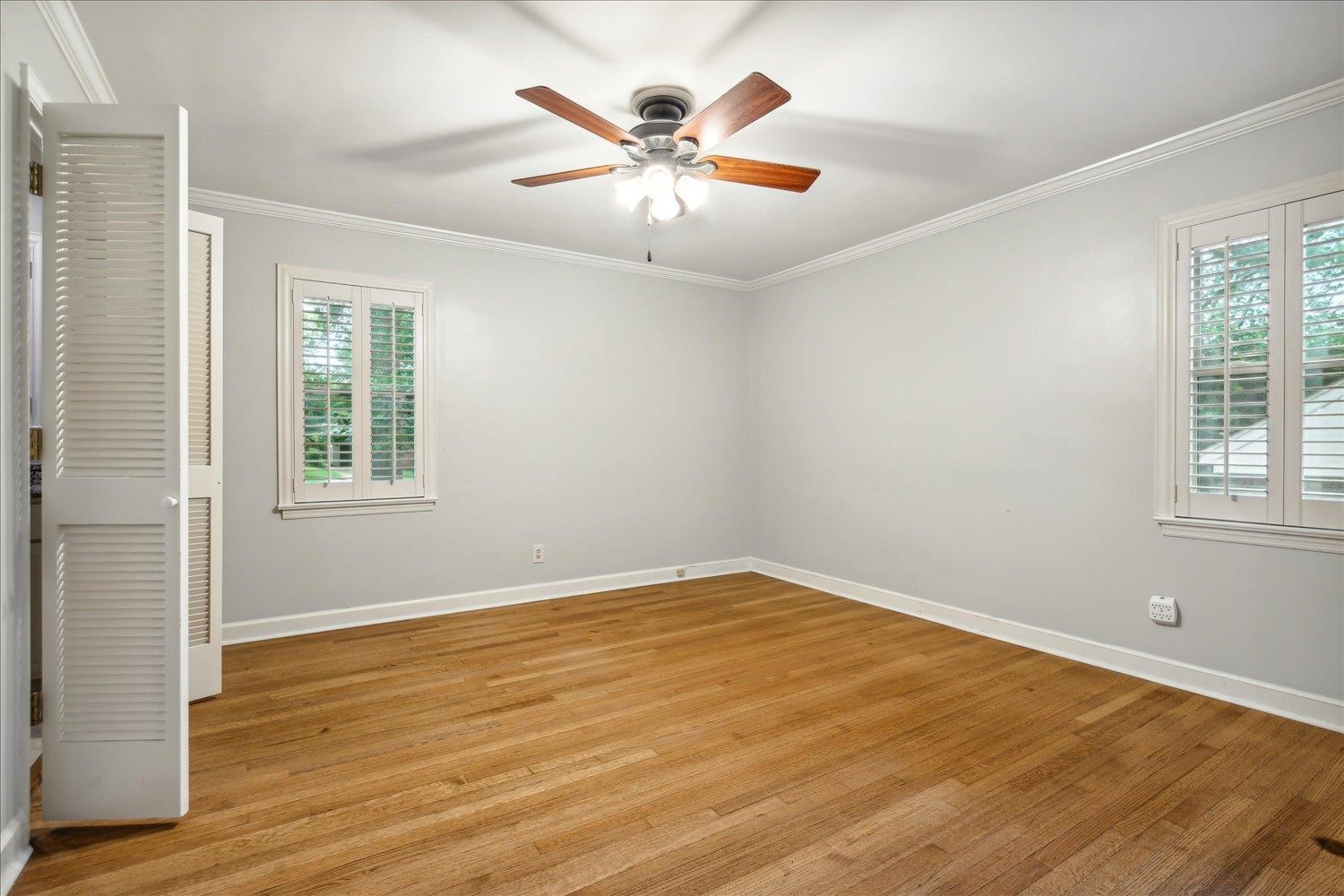 5517 Normandy Road Memphis, TN 38120 - Photo 14 of 24 an empty room with wooden floor and windows