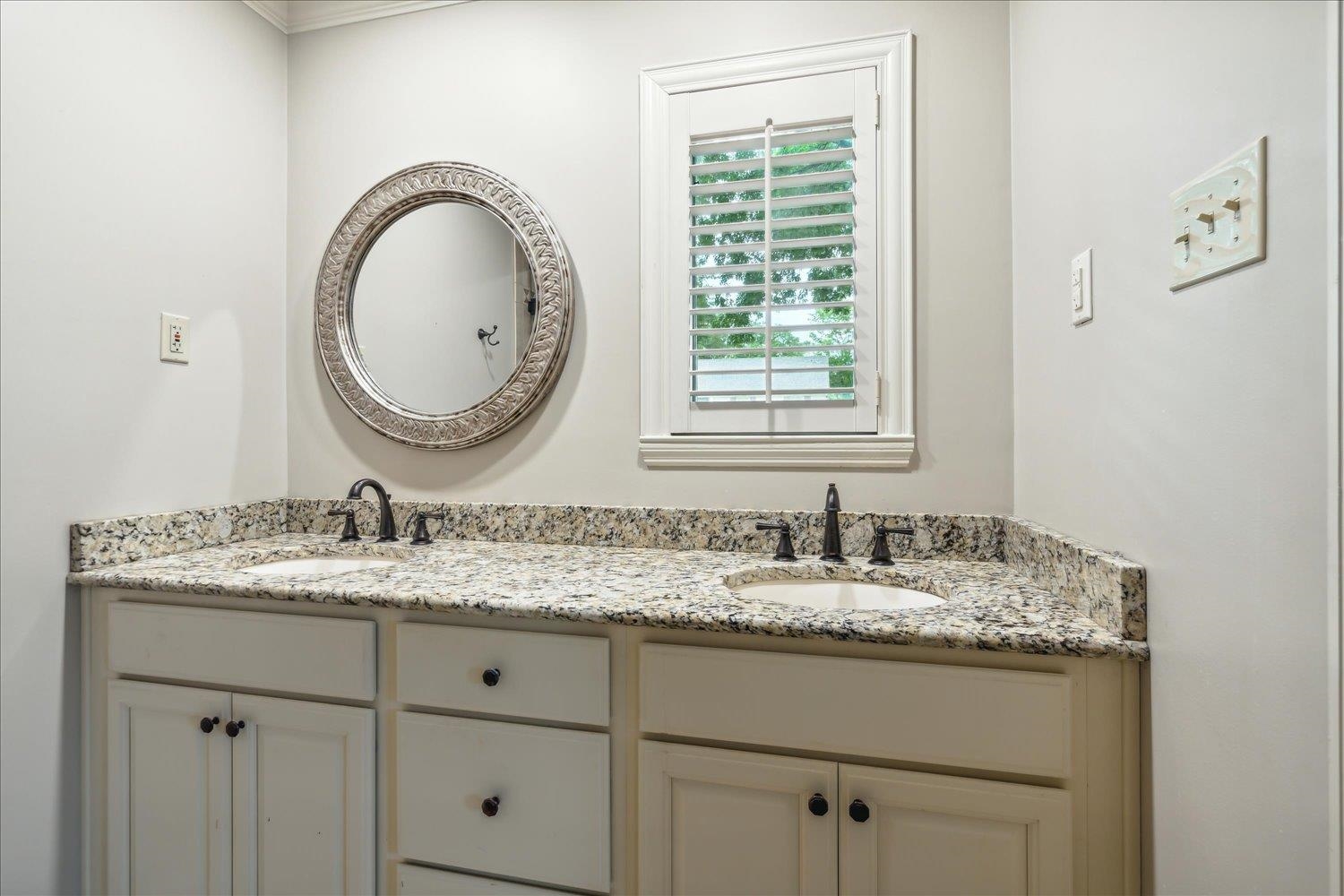5517 Normandy Road Memphis, TN 38120 - Photo 17 of 24 a bathroom with a granite countertop double vanity sink and a mirror
