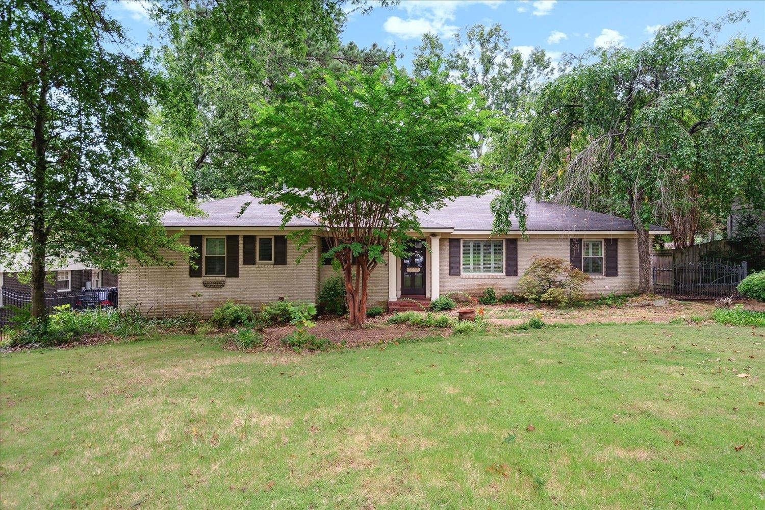 5517 Normandy Road Memphis, TN 38120 - Photo 2 of 24 a front view of a house with a garden