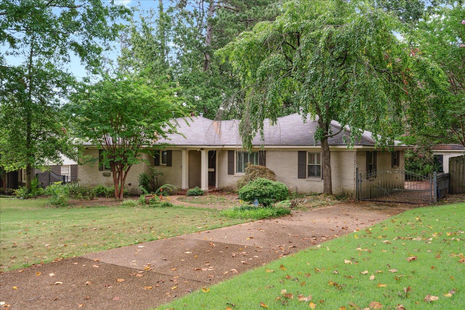 5517 Normandy Road Memphis, TN 38120 - Photo 3 of 24 a front view of a house with a garden and tree