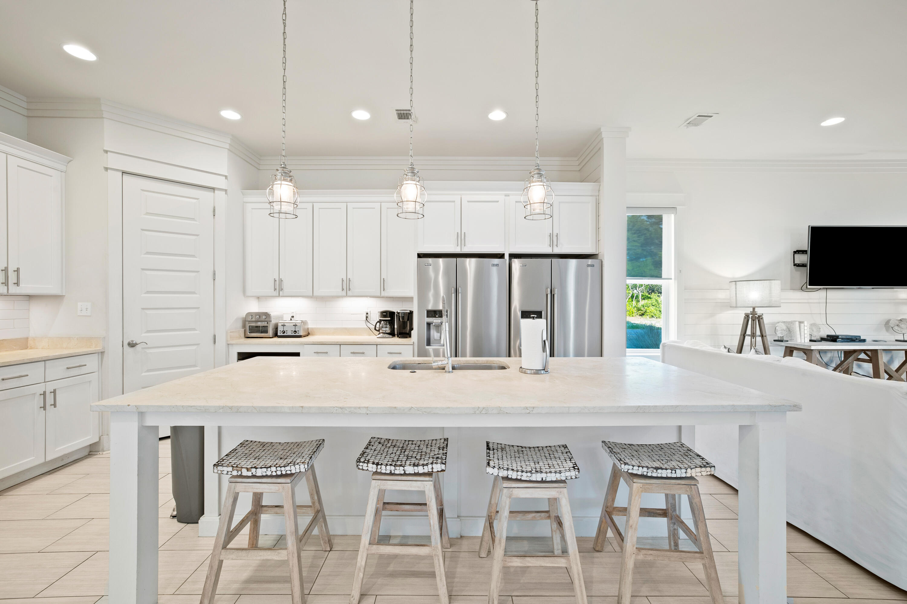 114 South Wall Street Inlet Beach, FL 32461 - Photo 14 of 62 a kitchen with stainless steel appliances kitchen island a table chairs sink and microwave
