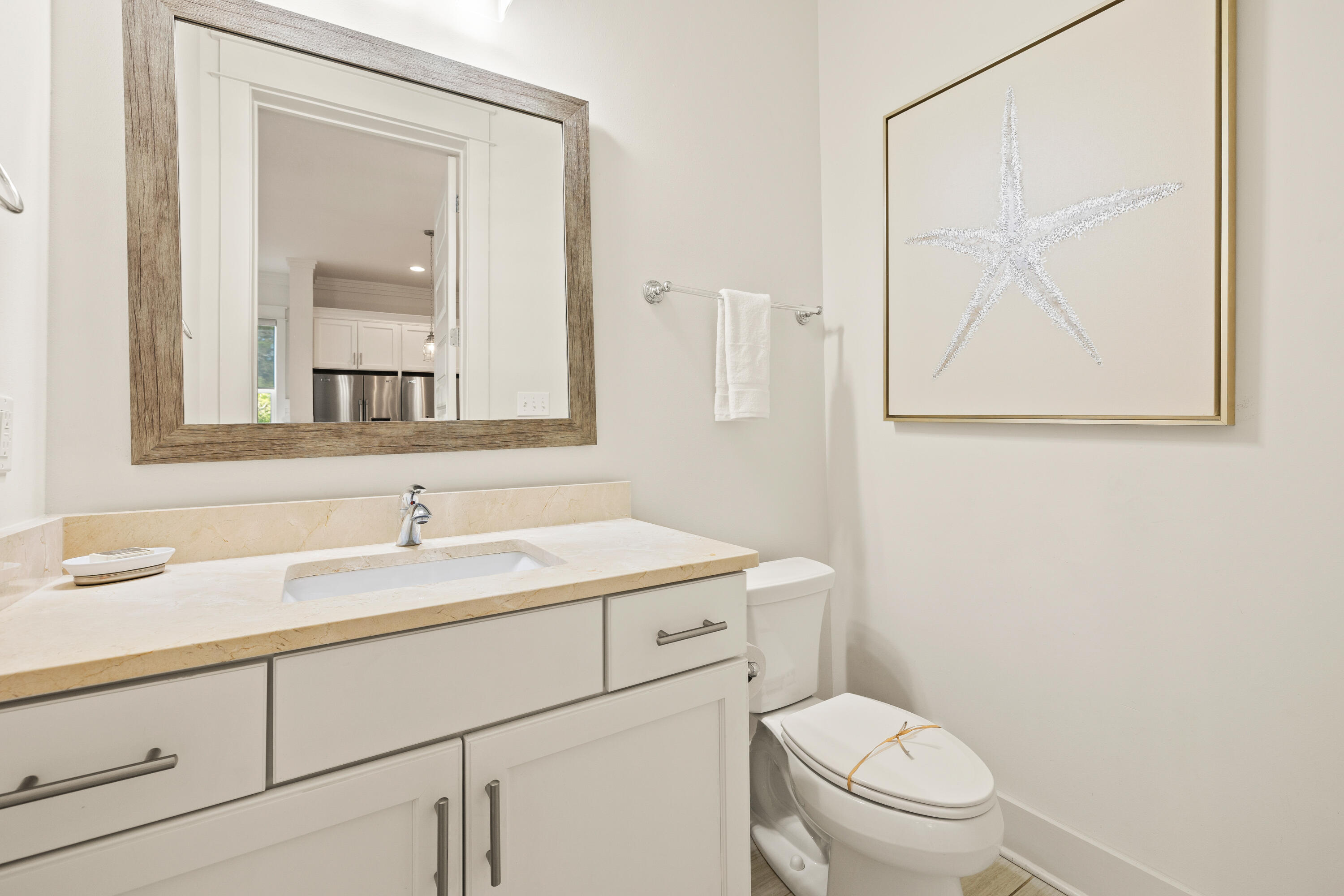 114 South Wall Street Inlet Beach, FL 32461 - Photo 21 of 62 a bathroom with a toilet sink vanity and mirror