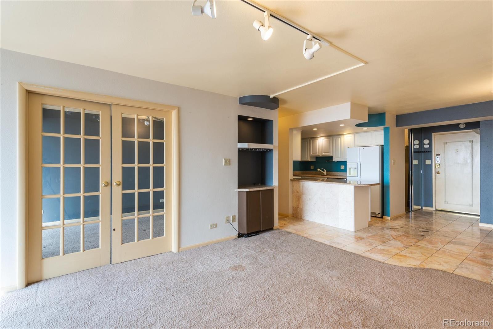 1313 North Williams Street, Unit 906 Denver, CO 80218 - Photo 14 of 31 a view of an empty room with kitchen and a window