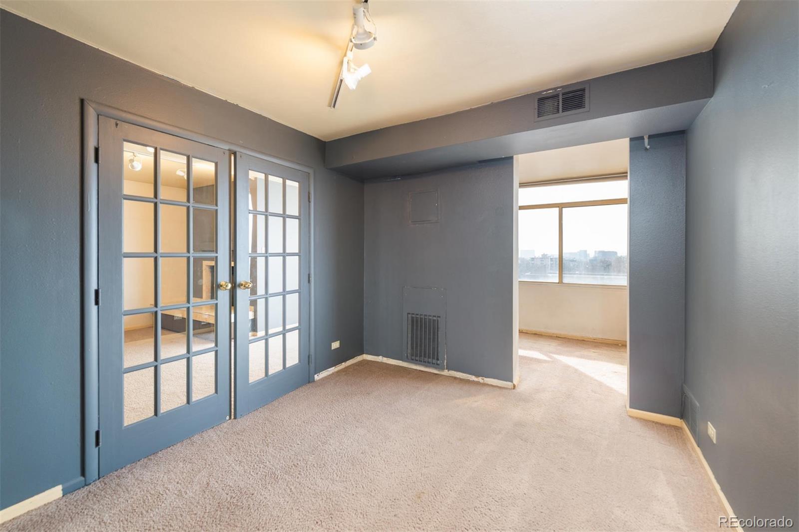 1313 North Williams Street, Unit 906 Denver, CO 80218 - Photo 15 of 31 an empty room with chandelier fan and windows