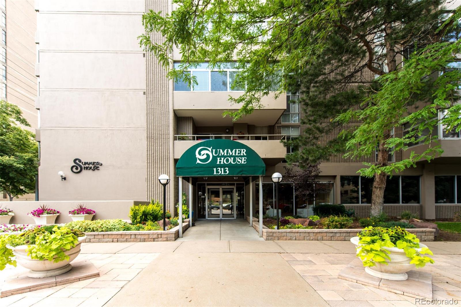 1313 North Williams Street, Unit 906 Denver, CO 80218 - Photo 2 of 31 a front view of a house with a garden