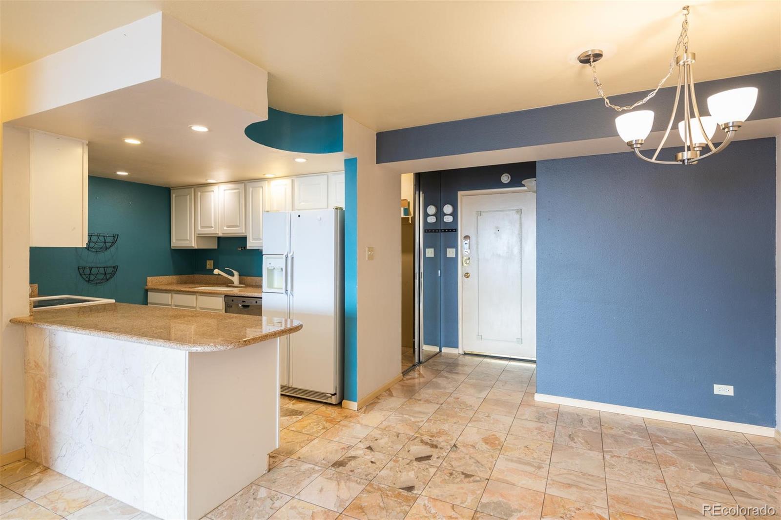 1313 North Williams Street, Unit 906 Denver, CO 80218 - Photo 6 of 31 a kitchen with stainless steel appliances granite countertop a sink a refrigerator and a stove