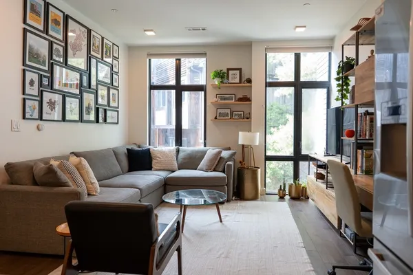a living room with furniture fireplace and a large window
